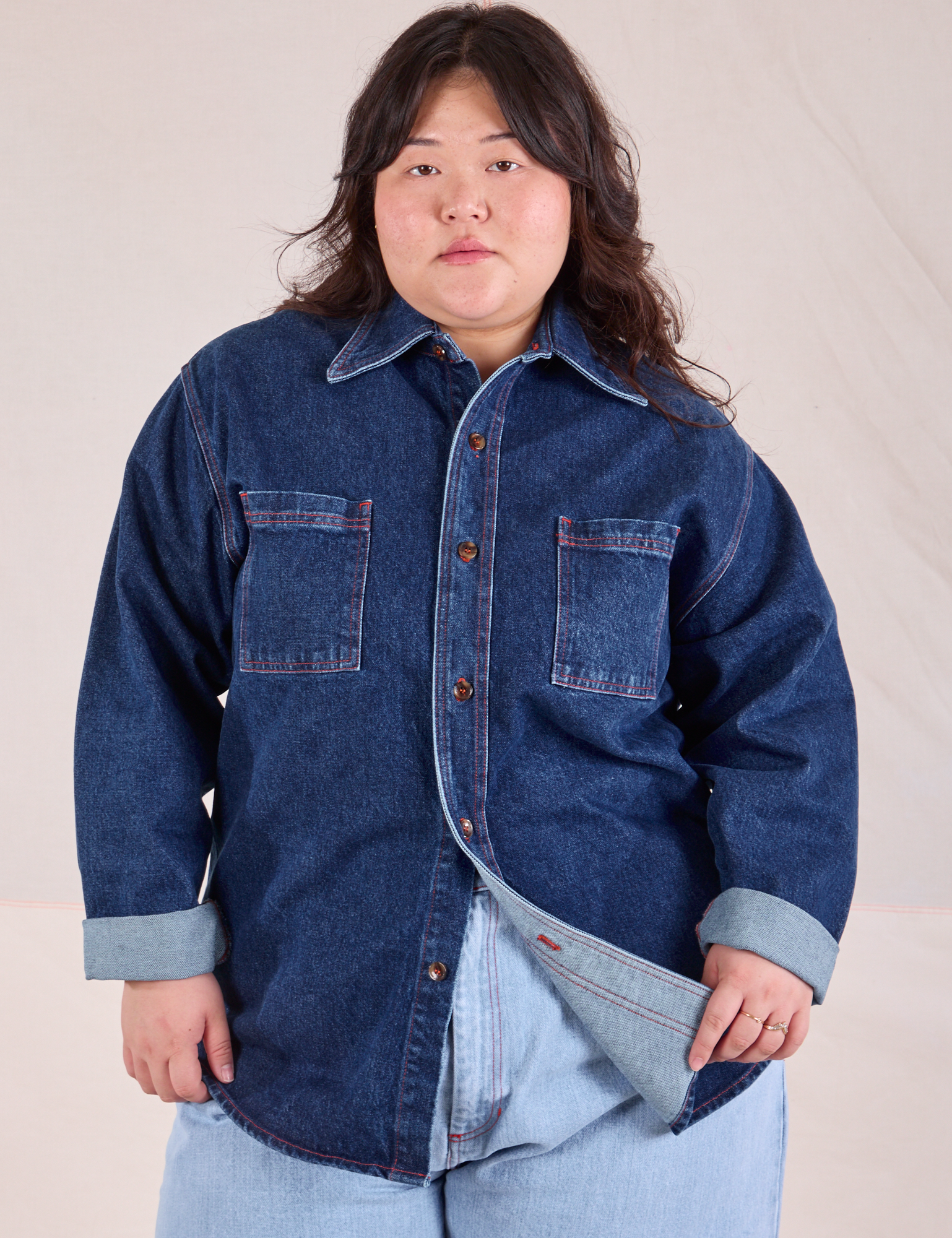 Ashley is wearing a buttoned up Denim Overshirt in Dark Wash