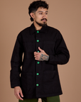Jesse is wearing a buttoned up Ripstop Field Coat in Basic Black