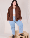 Ashley is wearing Flannel Overshirt in Fudgesicle Brown and light wash Carpenter Jeans
