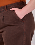 Close up of Lish's hand in the front pocket of Overdyed Denim Trouser in Fudge