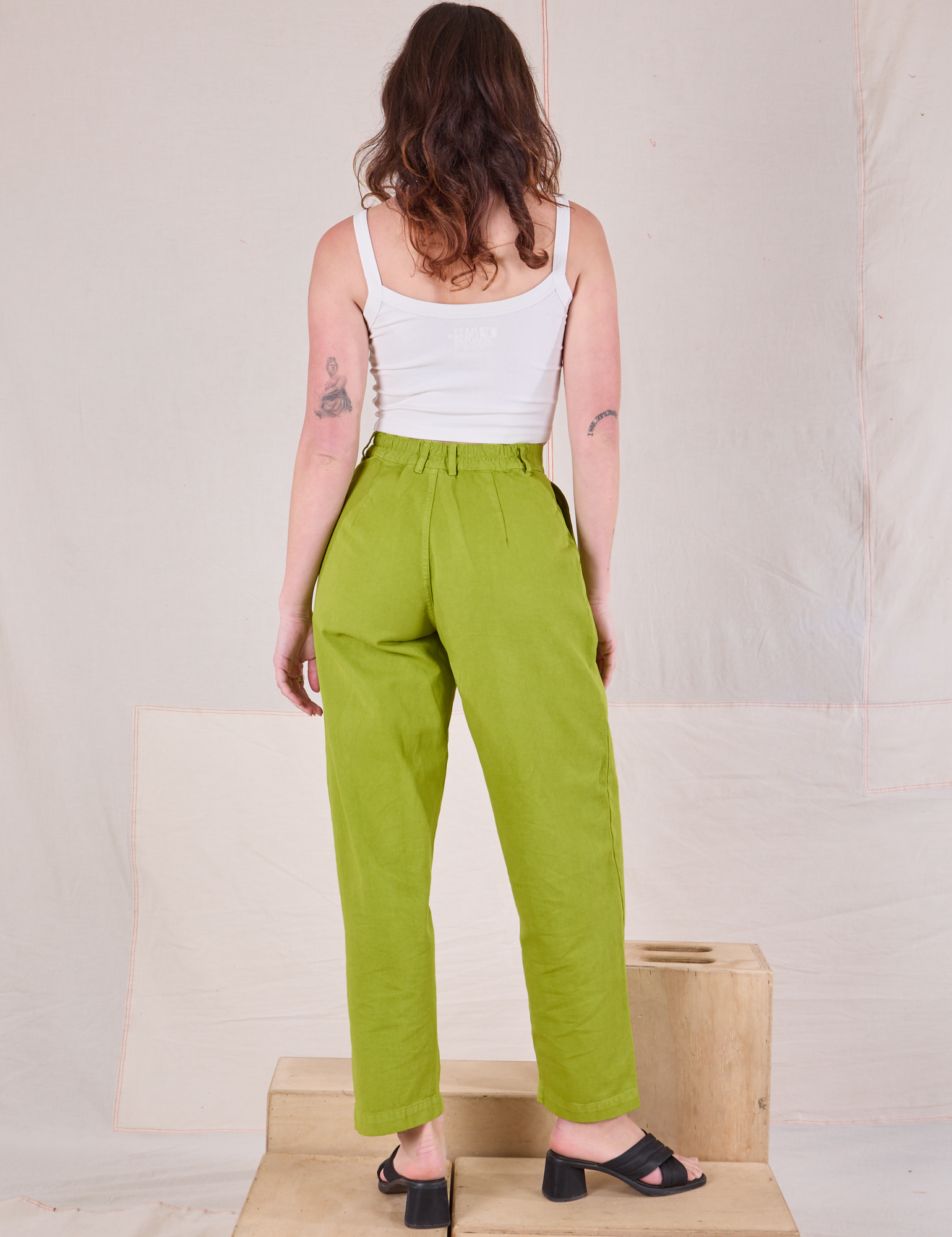 Back view of Heavyweight Trousers in Gross Green and Cami in vintage tee off-white on Alex