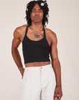 Jerrod is 6'3" and wearing XS Halter Top in Basic Black paired with vintage off-white Western Pants