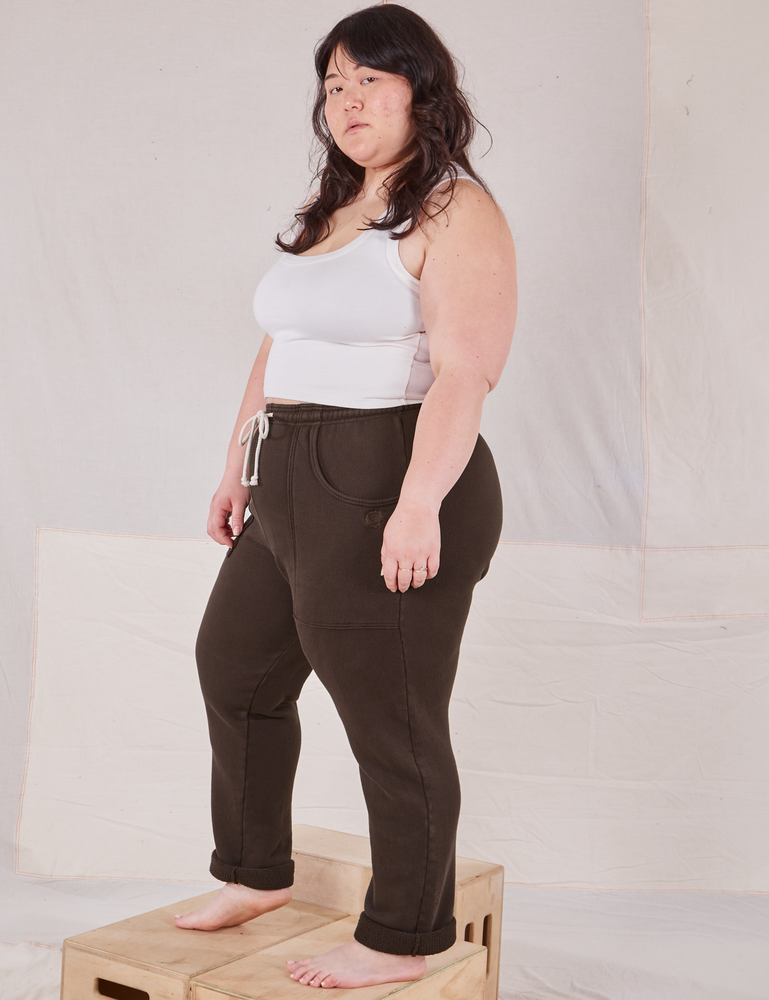 Side view of Rolled Cuff Sweat Pants in Espresso Brown and Cropped Tank in vintage tee off-white on Ashley