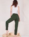 Back view of Rolled Cuff Sweat Pants in Swamp Green and vintage off-white Cropped Tank on Alex