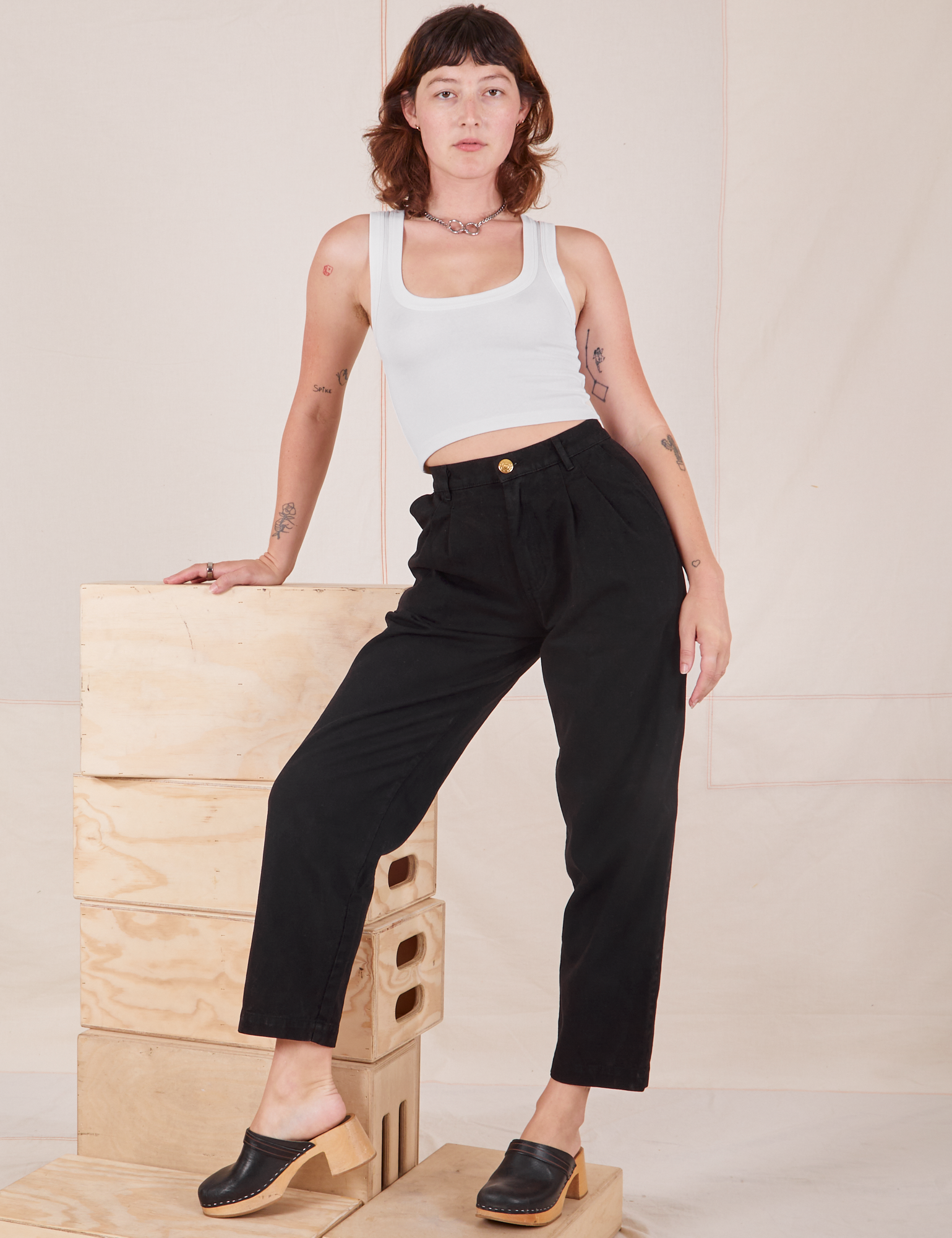Alex is wearing Heavyweight Trousers in Basic Black and Cropped Tank Top in vintage tee off-white 
