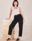 Alex is wearing Heavyweight Trousers in Basic Black and Cropped Tank Top in vintage tee off-white