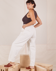 Side view of Heavyweight Trousers in Vintage Tee Off-White and espresso brown Cropped Tank Top worn by Tiara.