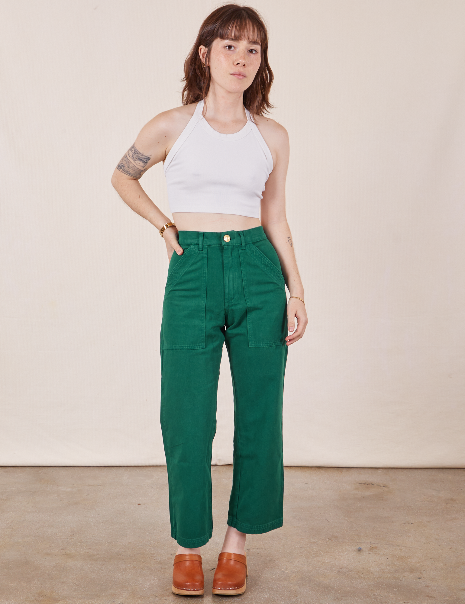 Hana is 5&#39;3&quot; and wearing XXS Petite Work Pants in Hunter Green paired with Halter Top in vintage tee off-white 