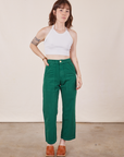 Hana is 5'3" and wearing XXS Petite Work Pants in Hunter Green paired with Halter Top in vintage tee off-white 