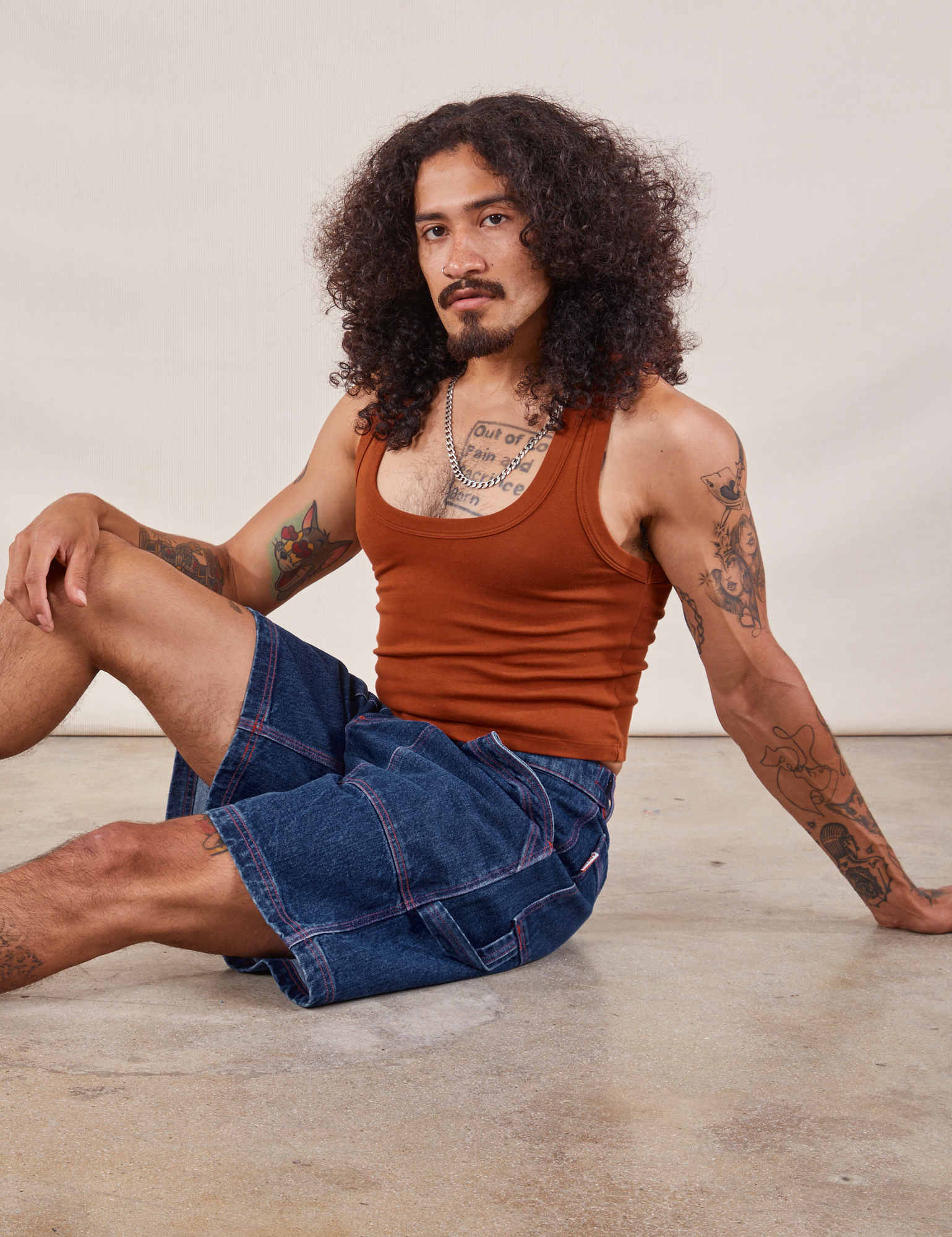 Jesse is wearing Carpenter Shorts in Dark Wash and burnt terracotta Cropped Tank