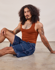 Jesse is wearing Carpenter Shorts in Dark Wash and burnt terracotta Cropped Tank
