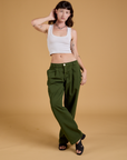 Alex is wearing Baggy Mid-Rise Trousers in Evergreen and a vintage tee white Cropped Tank