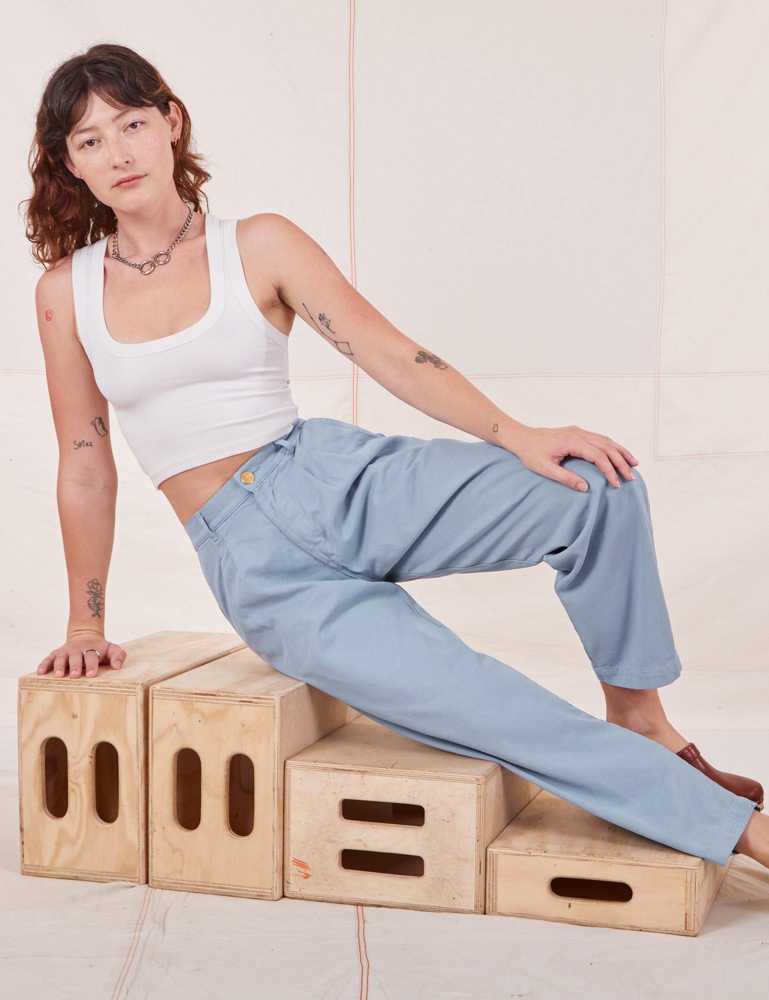Alex is wearing Heavyweight Trousers in Periwinkle and Cropped Tank Top in vintage tee off-white 