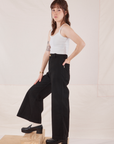 Side view of Petite Bell Bottoms in Basic Black and Cropped Cami in vintage tee off-white on Hana