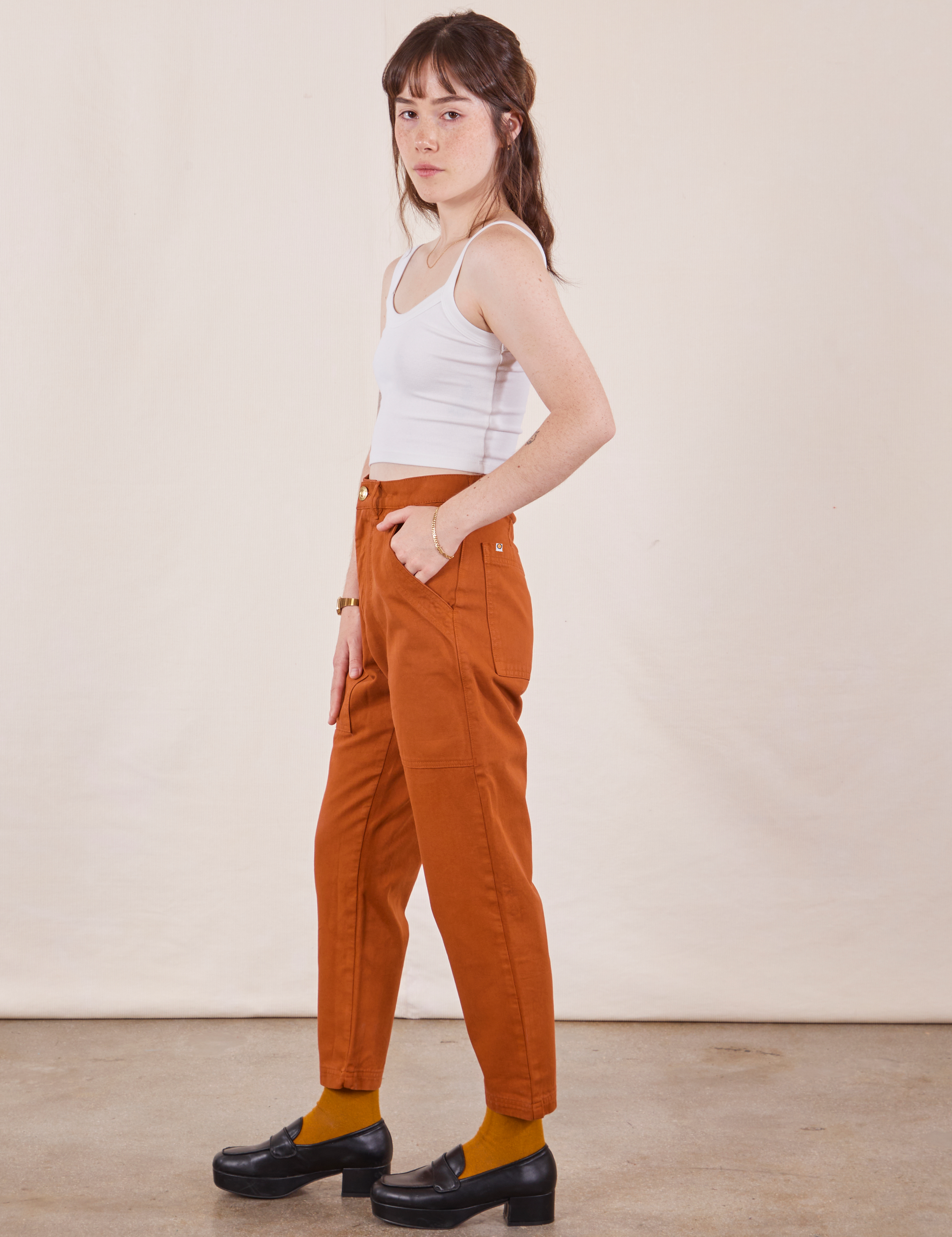 Side view of Petite Pencil Pants in Burnt Terracotta and Cropped Cami in vintage tee off-white on Hana