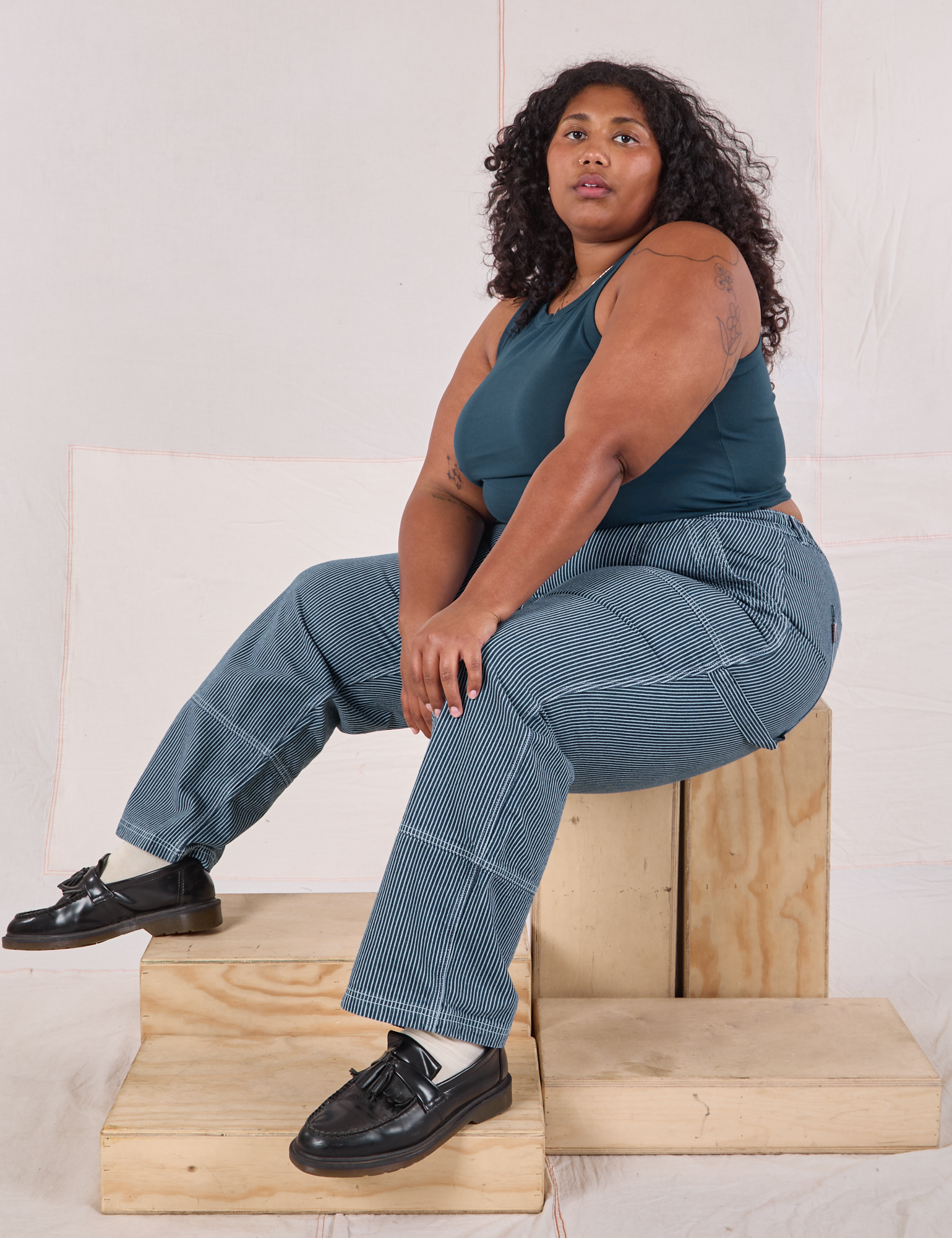 Morgan is wearing Railroad Carpenter Jeans in Baby Blue and marine blue Muscle Tee