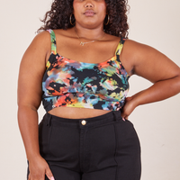 Morgan is 5'5" and wearing XL Cropped Cami in Rainbow Magic Waters paired with black Western Pants