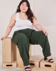 Ashley is wearing Heritage Trousers in Swamp Green and Cropped Tank Top in vintage tee  off-white