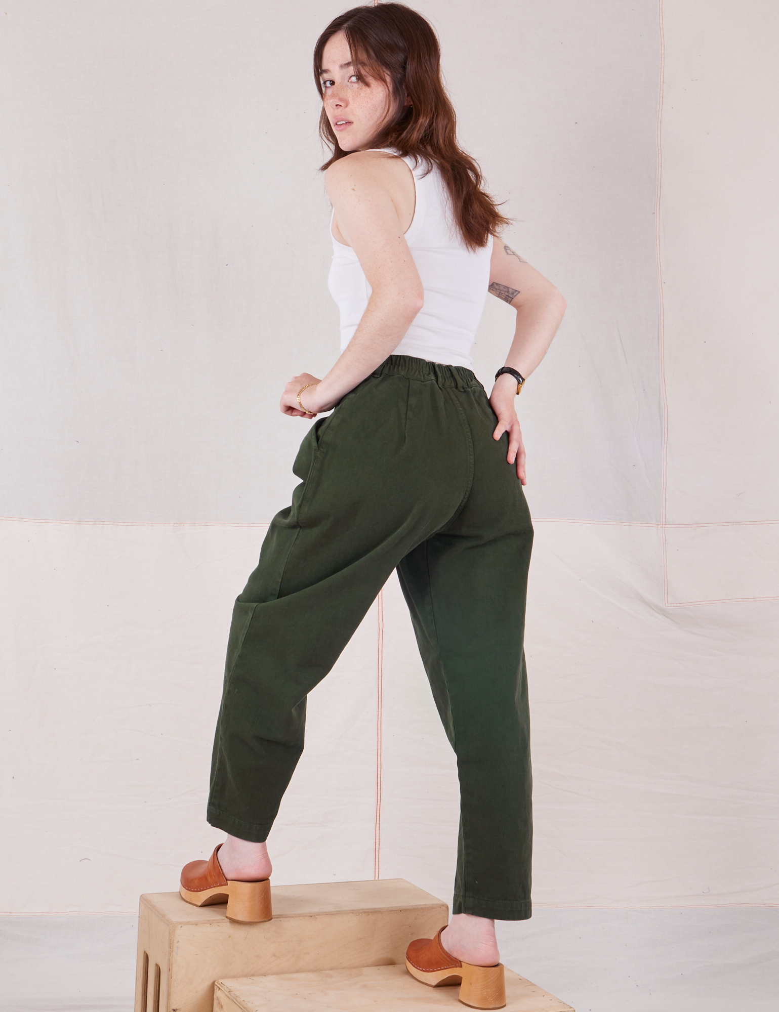 Back view of Heavyweight Trousers in Swamp Green and vintage tee off-white Cropped Tank on Hana