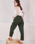 Back view of Heavyweight Trousers in Swamp Green and Cropped Tank Top in vintage tee off-white on Hana