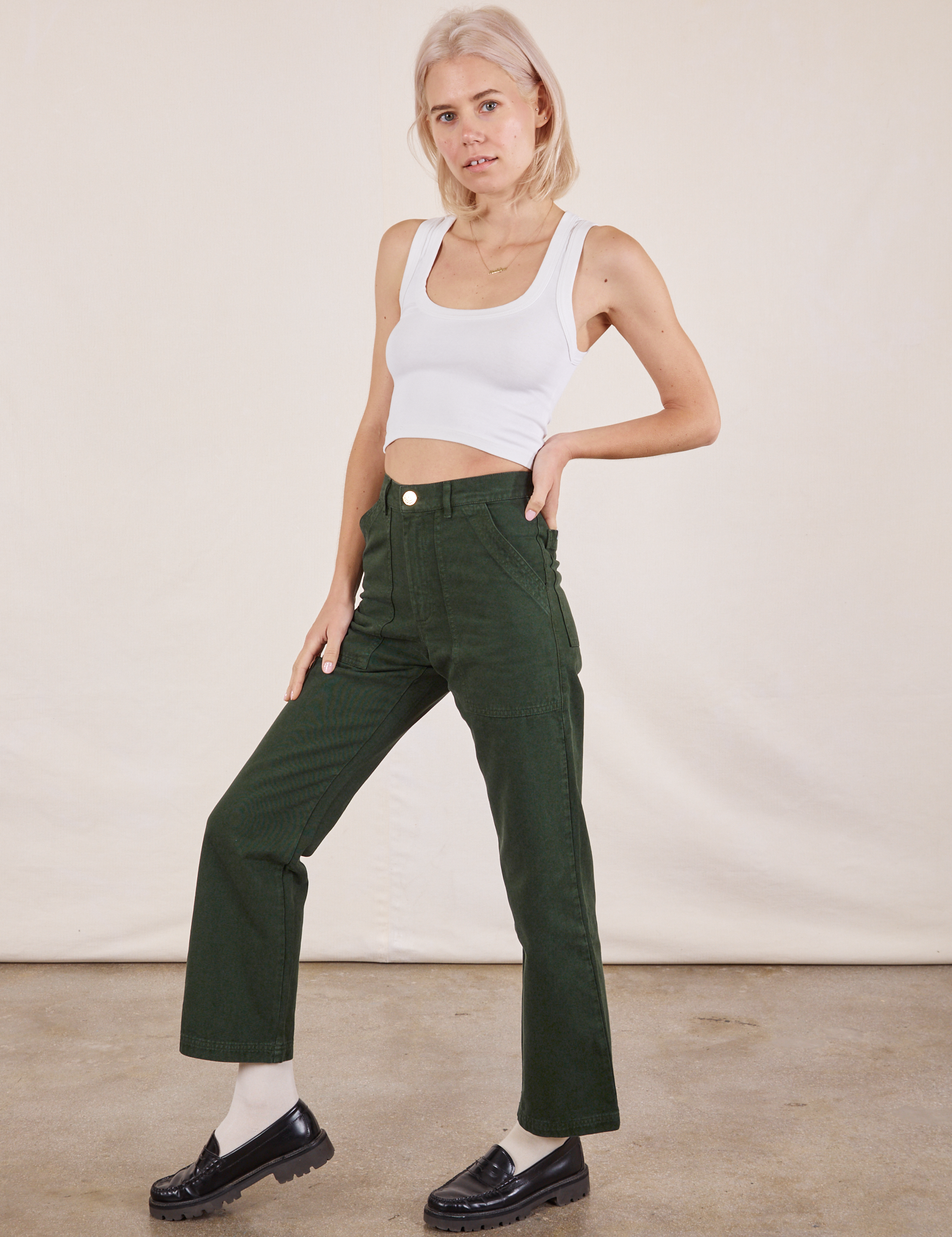 Angled front view of Work Pants in Swamp Green and vintage tee off-white Cropped Tank on Madeline
