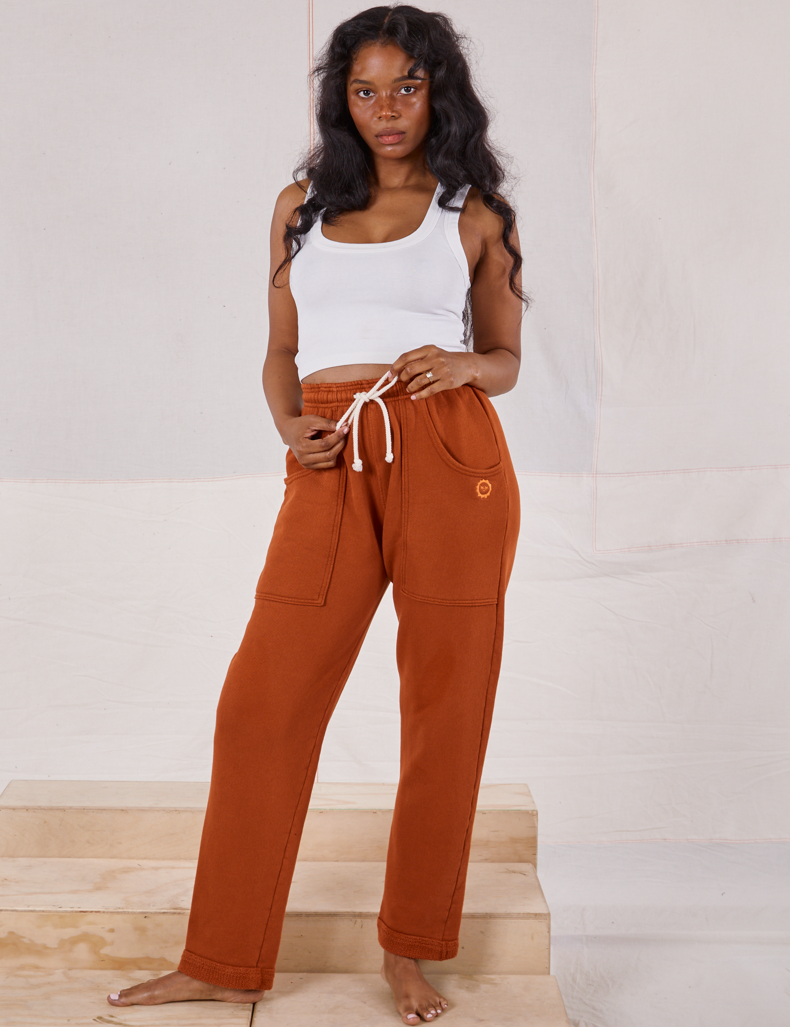 Kandia is 5&#39;3&quot; and wearing P Rolled Cuff Sweat Pants in Burnt Terracotta paired with Cropped Tank in vintage tee off-white
