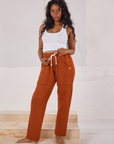 Kandia is 5'3" and wearing P Rolled Cuff Sweat Pants in Burnt Terracotta paired with Cropped Tank in vintage tee off-white