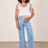 Jesse is wearing Cropped Tank Top in Vintage Off-White paired with light wash Sailor Jeans