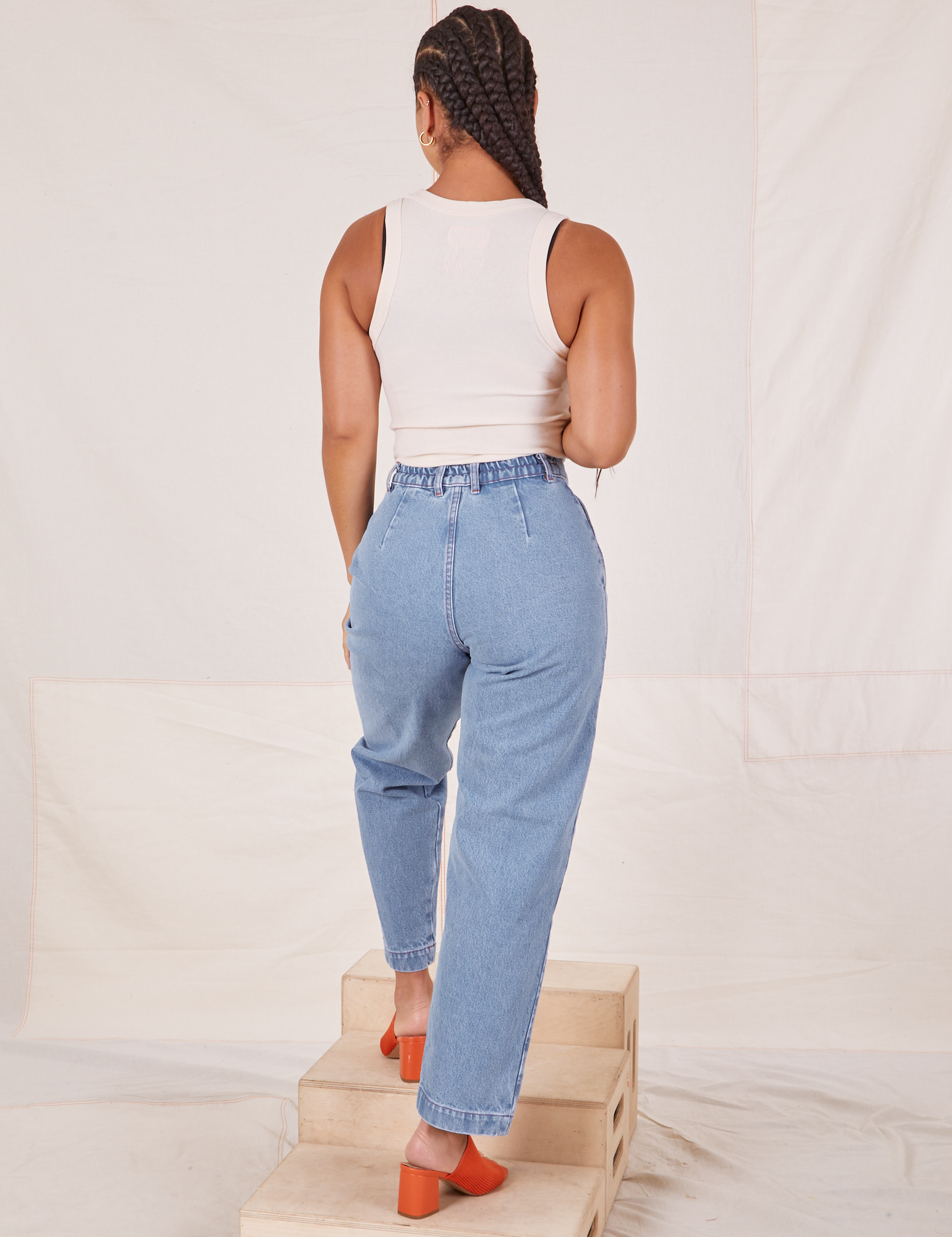 Back view of Denim Trouser Jeans in Light Wash and vintage off-white Tank Top worn by Gabi