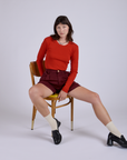Pleated Trouser Shorts in Red Wine and mustang red Long Sleeve Gingham Baby Tee on Alex