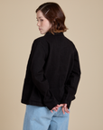 Angled back view of Work Jacket in Basic Black on Hana