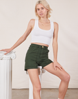 Madeline is wearing Classic Work Shorts in Swamp Green and a Cropped Tank Top in vintage tee off-white