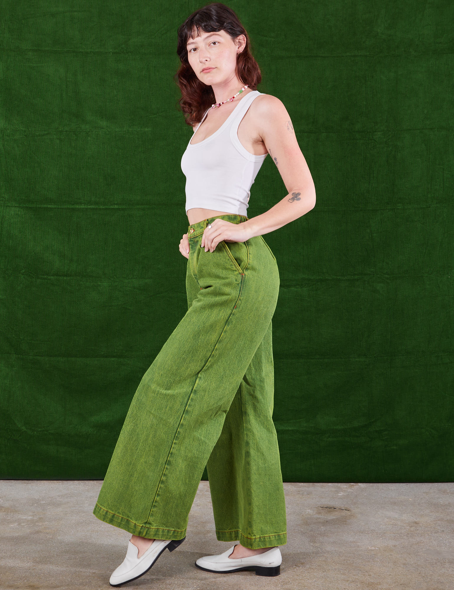 Side view of Overdyed Wide Leg Trousers in Gross Green and Cropped Tank Top in vintage tee off-white  on Alex