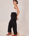 Side view of Denim Trouser Jeans in Black and Tank Top in vintage tee off-white worn by Tiara.