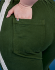 Close up of Ashley's hand in the back pocket of Painted Work Pants in Evergreen