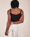 Back view of Cropped Cami in Basic Black and vintage tee off-white Western Pants worn by Jerrod