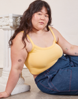 Ashley is wearing Cropped Cami in Butter Yellow and dark wash Carpenter Jeans