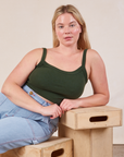 Lish is wearing Cropped Cami in Swamp Green and lightwash Carpenter Jeans