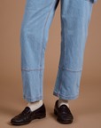 Carpenter Jeans in Light Wash pant leg close up on Quinn