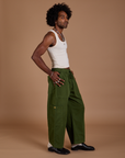 Side view of Drop Pocket Cargo Pants in Evergreen and Tank Top in vintage tee white on Jerrod