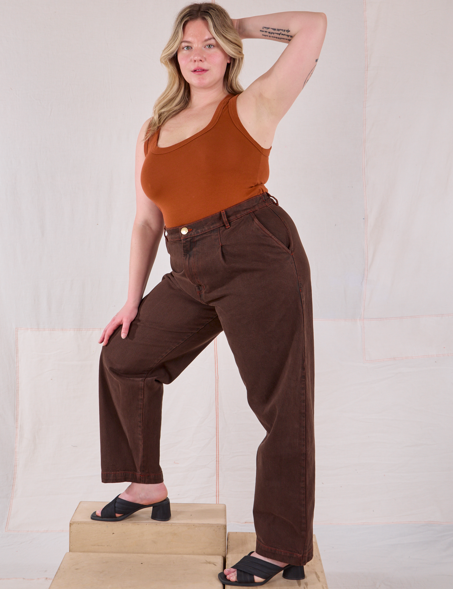 Angled front view of Overdyed Denim Trouser in Fudge and burnt terracotta Cropped Tank on Lish