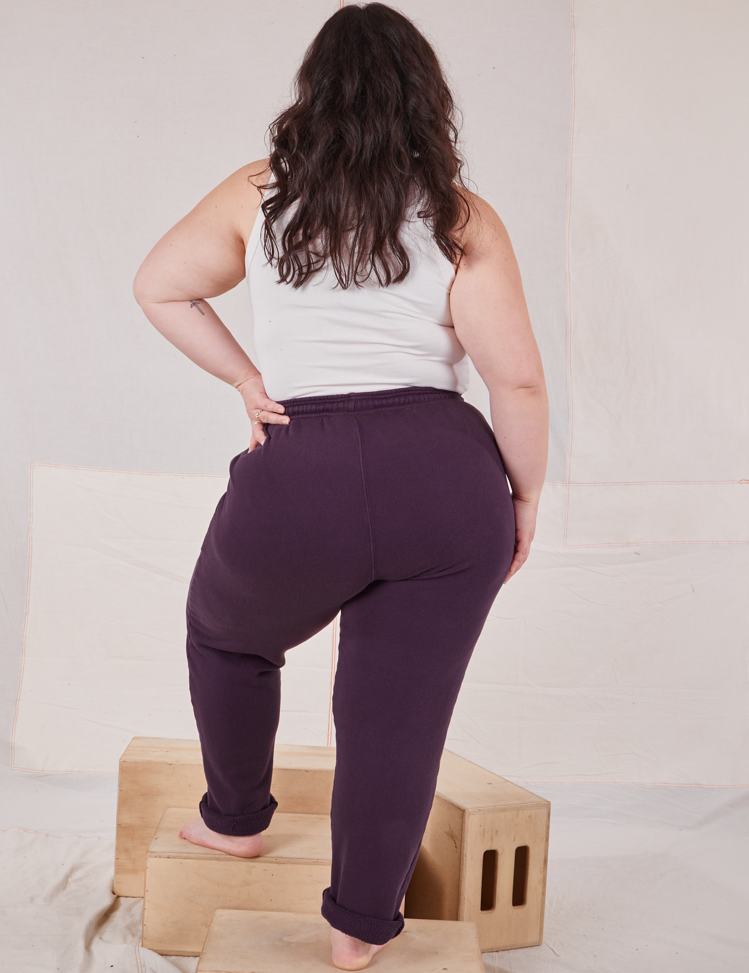 Back view of Rolled Cuff Sweat Pants in Nebula Purple and vintage off-white Cropped Tank on Ashley