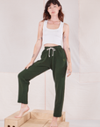 Alex is wearing Rolled Cuff Sweat Pants in Swamp Green and vintage off-white Cropped Tank