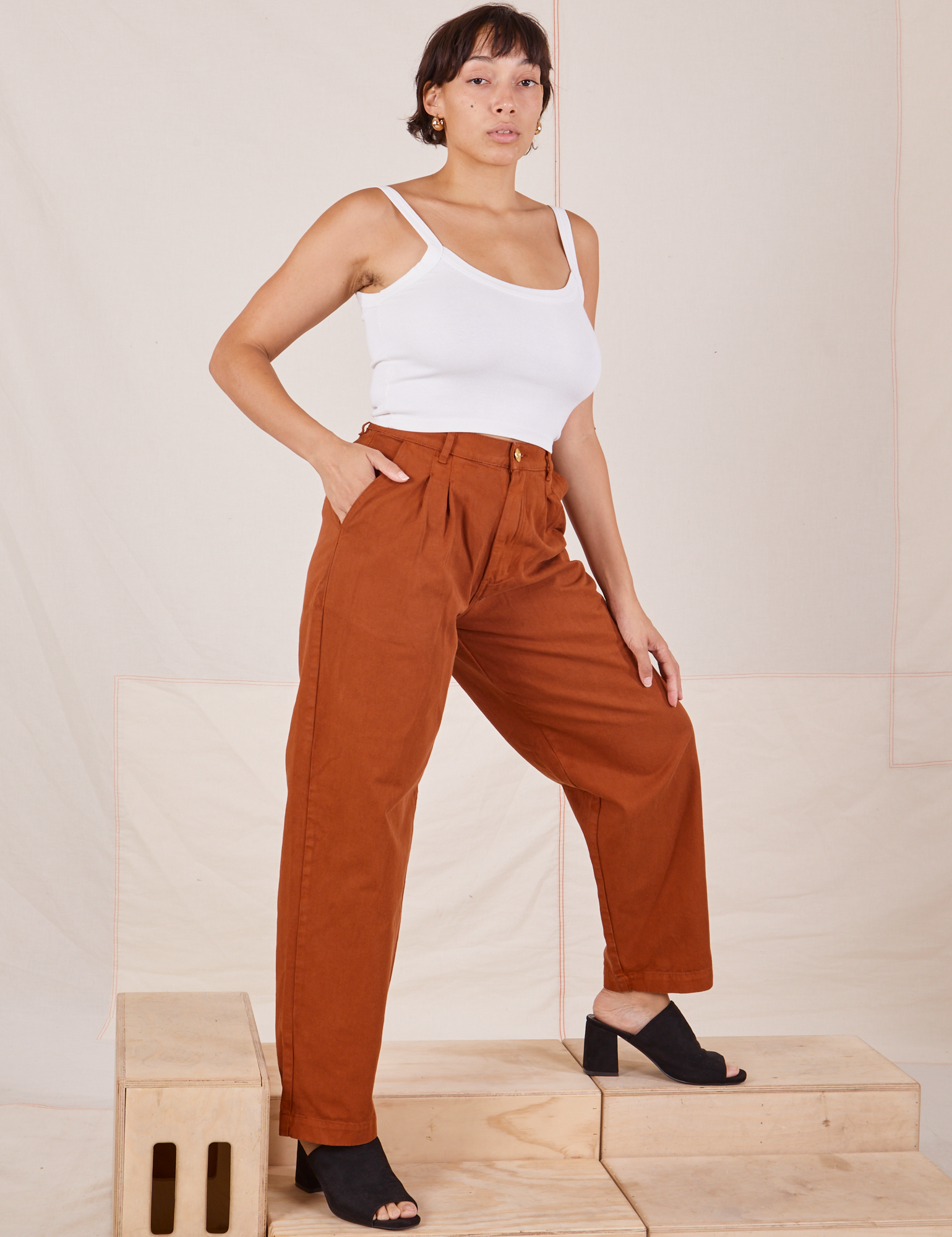 Angled view of Heavyweight Trousers in Burnt Terracotta and Cropped Cami in vintage tee off-white worn by Tiara
