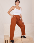 Angled view of Heavyweight Trousers in Burnt Terracotta and Cropped Cami in vintage tee off-white worn by Tiara