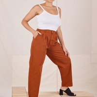 Angled view of Heavyweight Trousers in Burnt Terracotta and vintage off-white Cropped Cami worn by Tiara