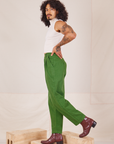 Side view of Heavyweight Trousers in Lawn Green and Sleeveless Turtleneck in vintage tee off-white worn by Jesse
