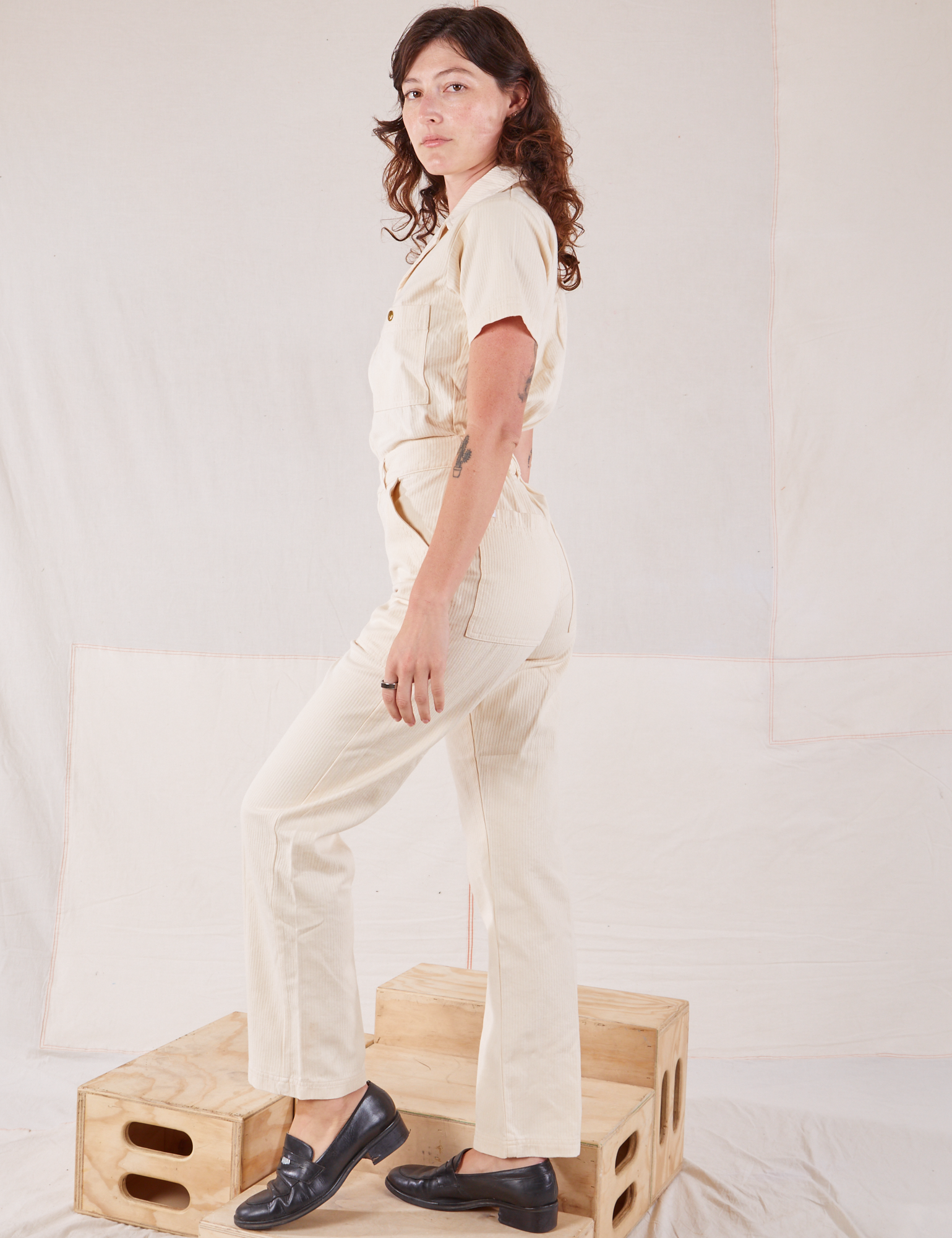 Heritage Short Sleeve Jumpsuit in Natural side view on Alex