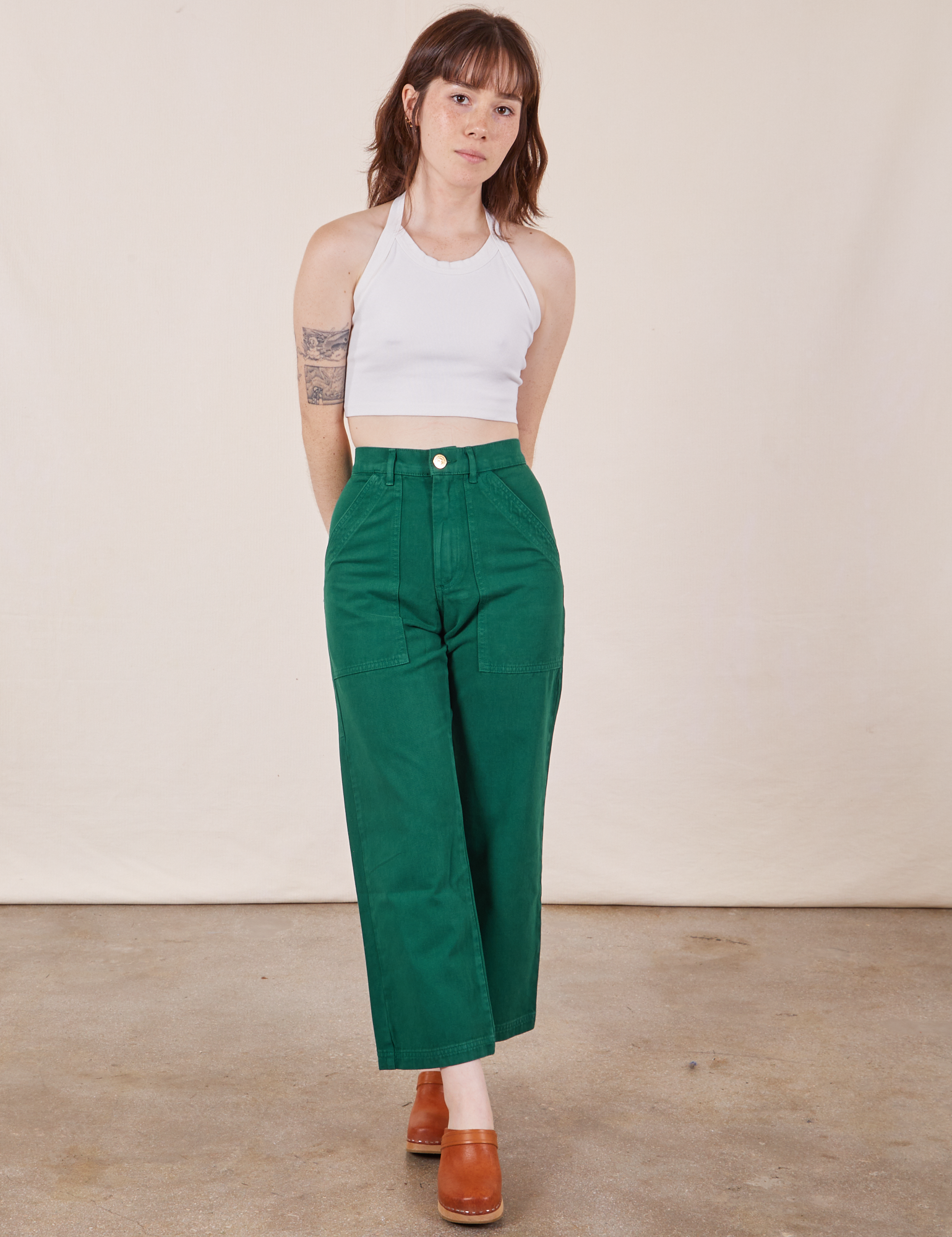 Hana is wearing Work Pants in Hunter Green and Halter Top in vintage tee off-white