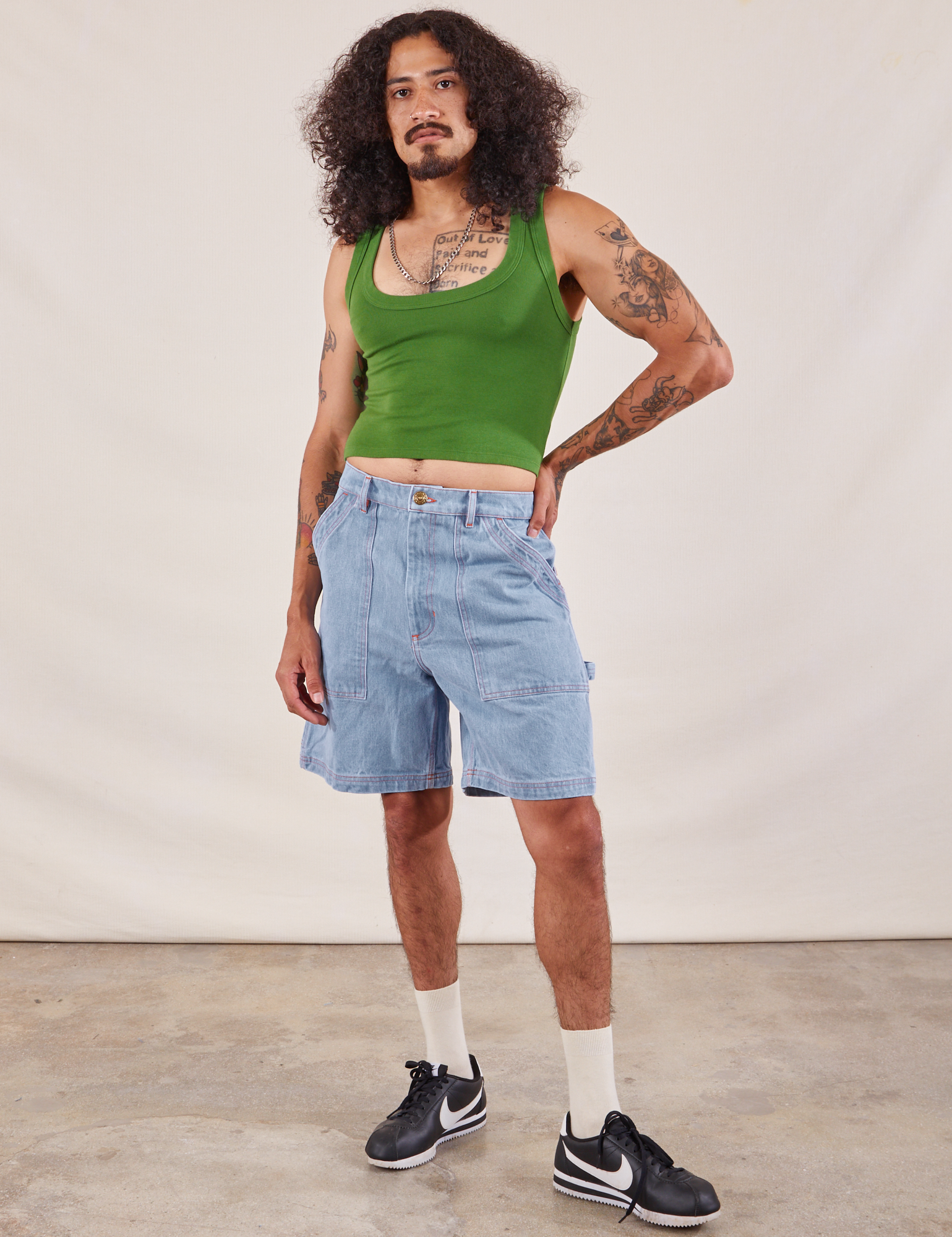 Jesse is 5'8" and wearing S Carpenter Shorts in Light Wash paired with lawn green Cropped tank